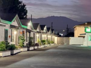a row of houses with lights on a street at Scenic Motel - El Monte in El Monte