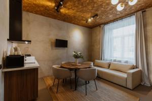 a living room with a table and a couch at Buntes nams l Self check-in l Private entrance in Limbaži