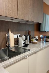 a kitchen with a sink and a counter top at Velvet Studio in Zamość