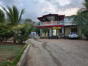 a building with a car parked in front of it at Shafi Villa in Neral