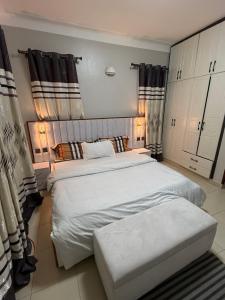 a bedroom with two twin beds and curtains at Summer villas in Kampala
