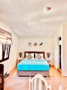 a bedroom with a bed and two tables at GREEN and BLUE VILLA in Glykadi