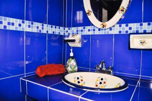 a blue bathroom with a sink and a mirror at Casa Manzanos in Guanajuato +116 photos