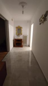 an empty room with a mirror on the wall at Avaton Myrina Apartment in Myrina