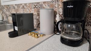 a kitchen counter with a blender and a tv at Avaton Myrina Apartment in Myrina