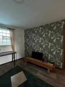 a living room with a flat screen tv on a wall at Cozy & modern apartment in Willstätt in Willstätt