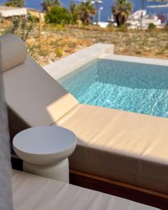 a swimming pool with a toilet sitting next to a tub at Thea Syros in Ermoupoli