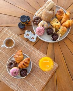 two plates of different types of pastries on a table at Thea Syros in Ermoupoli