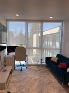 a living room with a blue couch and a desk at Executive 2 bed luxury Suit in Surrey