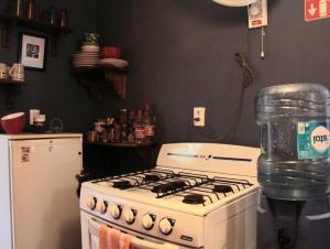 a kitchen with a white stove and a refrigerator at Isla Mujeres Punta Norte Private Bedroom 1 in Isla Mujeres +2 photos