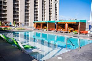 a swimming pool with chairs and a building at Plaza Hotel & Casino in Las Vegas