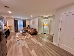 a living room with a couch and a table at The Cozy Suite - 1BR with Free Parking in Paterson