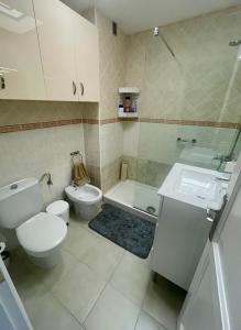 a bathroom with a toilet and a sink and a shower at C&M Dream House in Morro del Jable +5 photos