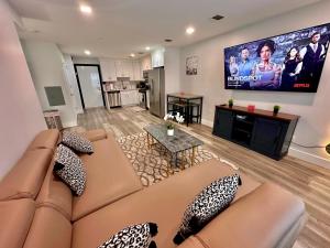 a living room with a couch and a flat screen tv at The Cozy Suite - 1BR with Free Parking in Paterson