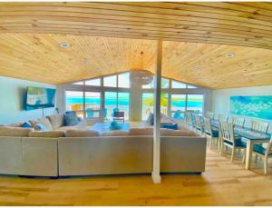 a living room with a large couch and a table at Beach Villa Blue Bahamas in Mayaguana Island