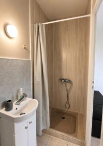 a bathroom with a shower and a sink at Ambre in Bény