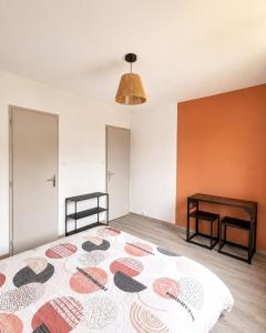 an empty room with a bed and a table at Ambre in Bény