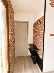 a mirror in a room with a brick wall at Ambre in Bény