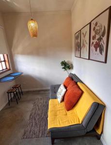 a living room with a couch with pillows on it at Vila Maytrea Chalés in Alto Paraíso de Goiás