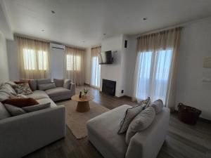 a living room with two couches and a table at Pool&River Villa in Alcoutim