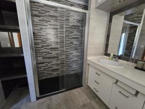 a bathroom with a glass shower and a sink at Pool&River Villa in Alcoutim +20 photos