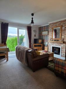 a living room with a couch and a fireplace at Tigh Na Mara in Furnace