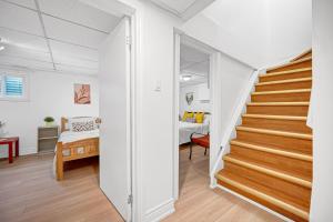 a room with a staircase and a bedroom at Bright 2BR Basement Apartment with Free Parking in Toronto