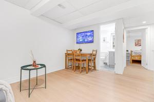 a dining room and living room with a table and chairs at Bright 2BR Basement Apartment with Free Parking in Toronto