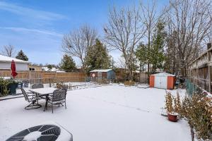 a patio with a table and chairs in the snow at Bright 2BR Basement Apartment with Free Parking in Toronto