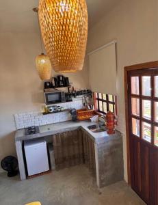 a kitchen with a sink and a counter top at Vila Maytrea Chalés in Alto Paraíso de Goiás
