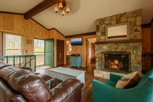 a living room with a couch and a fireplace at Mountain Stay Chalet in Beech Mountain
