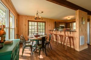 a kitchen and dining room with a table and chairs at Mountain Stay Chalet in Beech Mountain