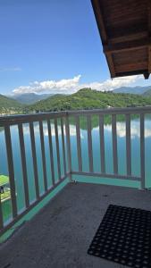 a balcony with a view of the water at Captains Seherzada Apartment in Železnička Stanica Ostrožac +3 photos