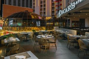 a restaurant with tables and chairs in a city at Plaza Hotel & Casino in Las Vegas