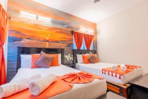 two beds in a room with a painting on the wall at "Hotel Relax" in Las Pozas
