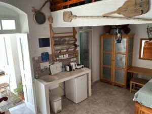 a kitchen with a counter in a room at Lindos Marianthi Studios in Lindos +30 photos