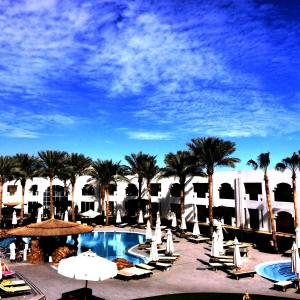 a view of a resort with a pool and palm trees at Xperience St. George Sharm El Sheikh in Sharm El Sheikh