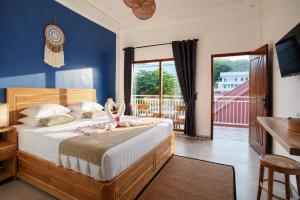 a bedroom with a bed with pink pelicans on it at Luciana Hotel in Labuan Bajo +18 photos