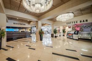 a shopping mall with a coffee bar and a chandelier at Plaza Hotel & Casino in Las Vegas +30 photos