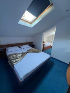 a bedroom with a large bed with a skylight at Vila Rosa Maria in Mangalia +9 photos