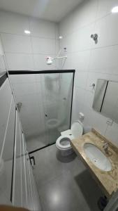 a bathroom with a toilet and a sink at Trilhas do Araguaia in Aruanã