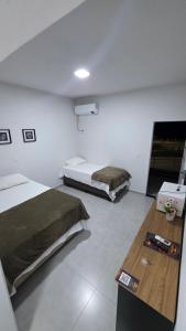 a bedroom with two beds and a basketball hoop at Trilhas do Araguaia in Aruanã