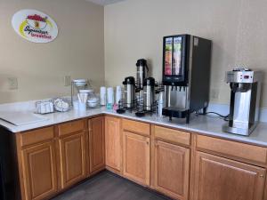 a kitchen counter with a coffee maker on top of it at Super 8 by Wyndham Lumberton NC in Lumberton +7 photos