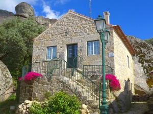 a stone house with a street light in front of it at Casas da Villa- Monsanto in Monsanto