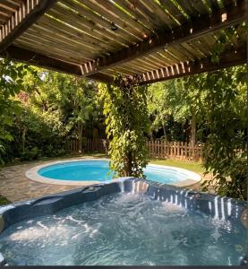 a pool with a pergola and a swimming pool at Apartamentos Casas Rurales "Paraje San Blas" TR-BA-00166 in Alburquerque
