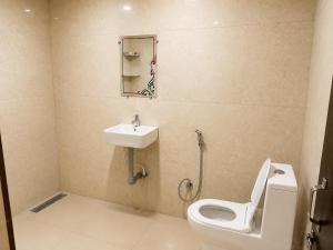 a bathroom with a toilet and a sink at JK Suites in Rāmachandrapuram