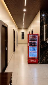 a cocacola soda vending machine in a hallway at JK Suites in Rāmachandrapuram