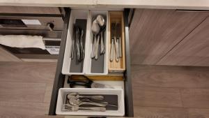 a drawer filled with utensils in a room at Cozy 1 bed and 1 bath in Surrey