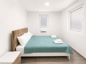 a white bedroom with a bed and a couch at Bate Bole Mountain Villa in Elshani +18 photos