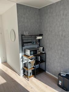 a room with a gray wall with a shelf at Stylish & modern Flat with large Sun Balcony in Bad Peterstal